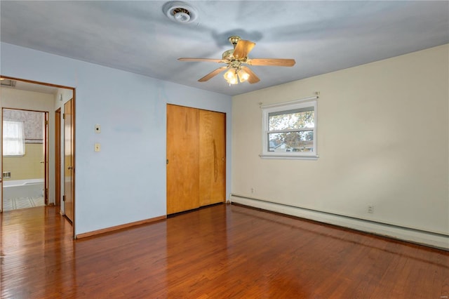 unfurnished bedroom featuring a closet, hardwood / wood-style floors, ceiling fan, and a baseboard heating unit