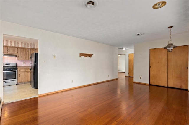 unfurnished living room with light hardwood / wood-style flooring