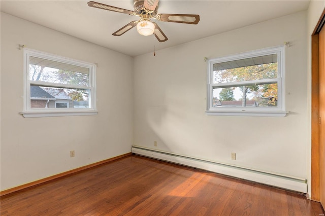 unfurnished room featuring ceiling fan, hardwood / wood-style flooring, baseboard heating, and plenty of natural light