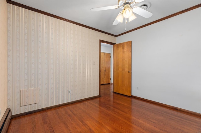 spare room with hardwood / wood-style flooring, ceiling fan, a baseboard heating unit, and ornamental molding