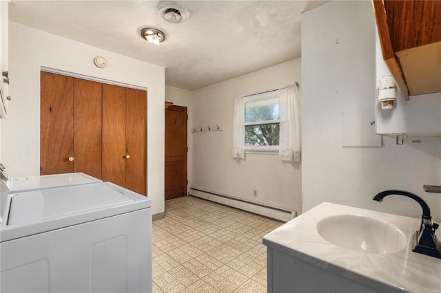 laundry area with separate washer and dryer, a baseboard radiator, and sink