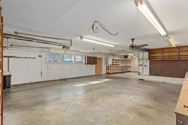 garage with a garage door opener and ceiling fan