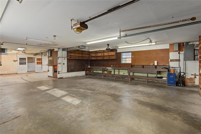 garage with electric panel and a garage door opener