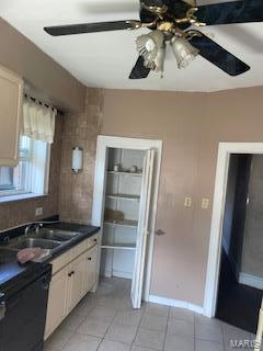 kitchen featuring dishwasher, sink, light tile patterned flooring, white cabinetry, and ceiling fan