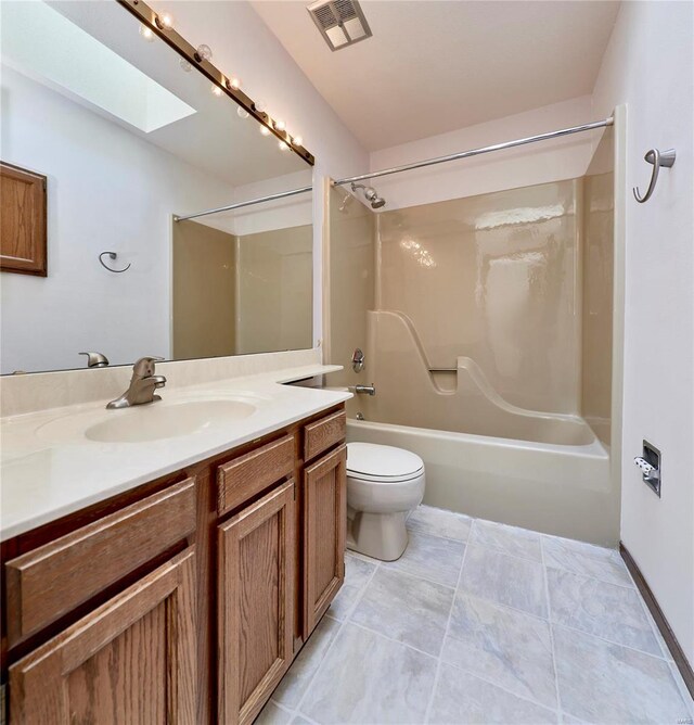 full bath featuring a skylight, visible vents, toilet, washtub / shower combination, and vanity