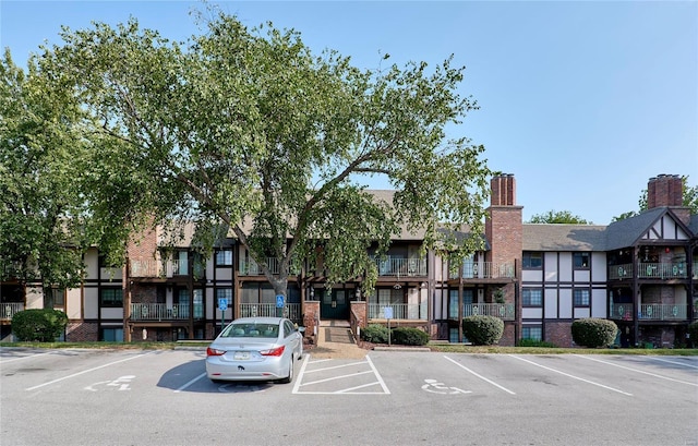 view of building exterior with uncovered parking