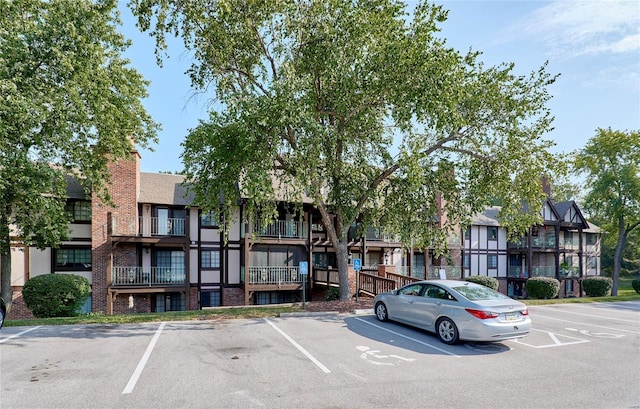 view of property featuring uncovered parking and a residential view