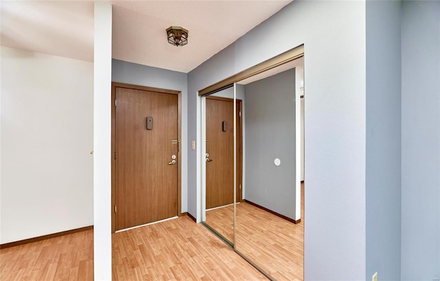 interior space featuring light wood-style flooring and baseboards