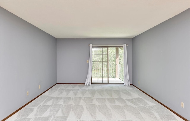 empty room with light carpet and baseboards