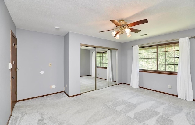 unfurnished bedroom with light colored carpet, visible vents, and baseboards