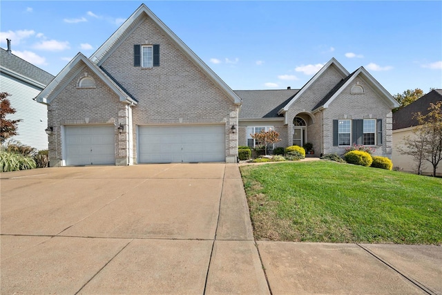 traditional-style house with concrete driveway, a front lawn, and brick siding