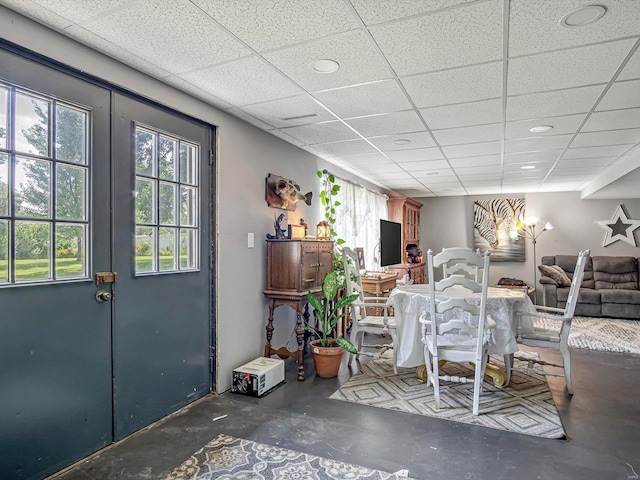 dining room featuring a drop ceiling