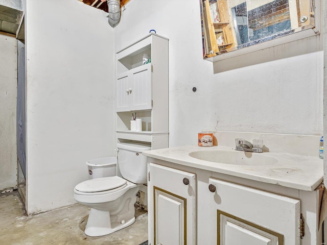 bathroom with concrete flooring, vanity, and toilet