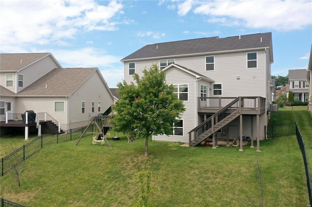 rear view of house with a lawn, central AC unit, a deck, and a playground