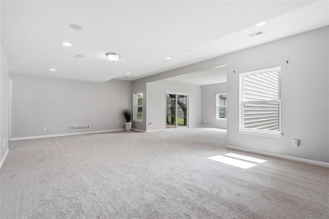 carpeted empty room with plenty of natural light