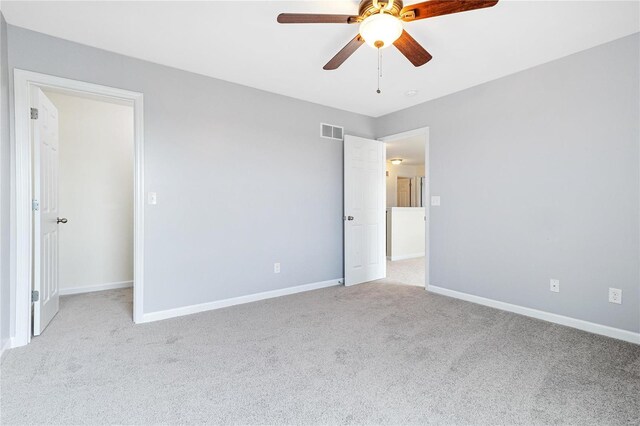 unfurnished bedroom with ceiling fan, a closet, and light colored carpet