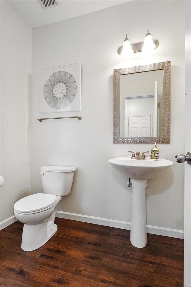 bathroom featuring hardwood / wood-style floors and toilet