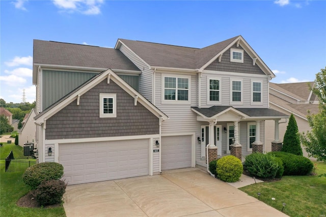 view of front facade with a garage, concrete driveway, and fence