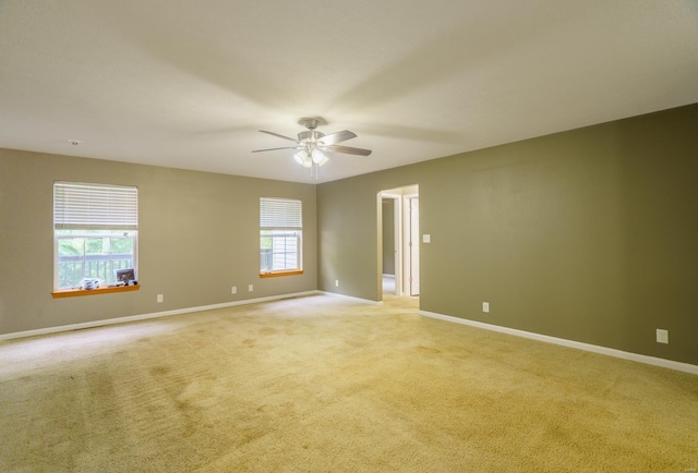 unfurnished room with ceiling fan and light carpet