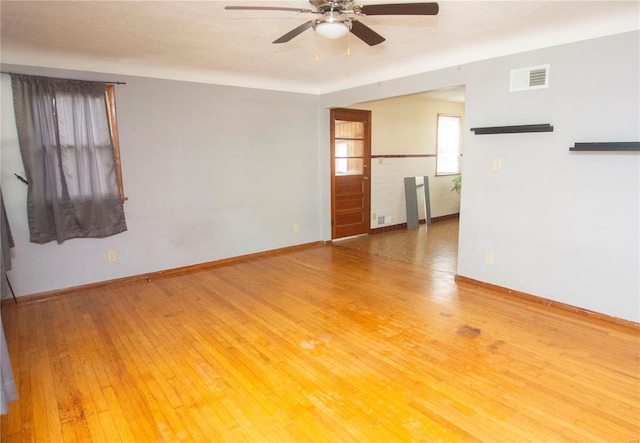 unfurnished living room featuring ceiling fan and hardwood / wood-style floors