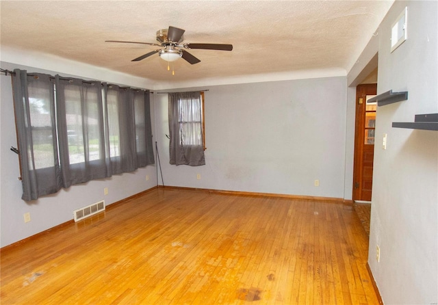 spare room featuring ceiling fan and hardwood / wood-style flooring