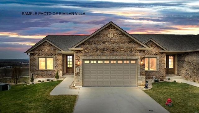 craftsman inspired home with a garage and a yard