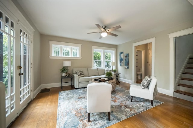 living room with ceiling fan and hardwood / wood-style flooring