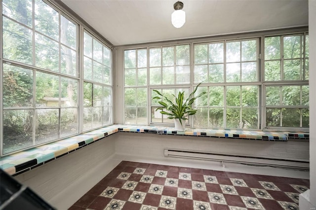 unfurnished sunroom with a baseboard heating unit