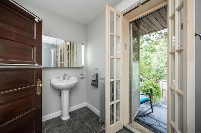 bathroom featuring french doors and tile patterned flooring