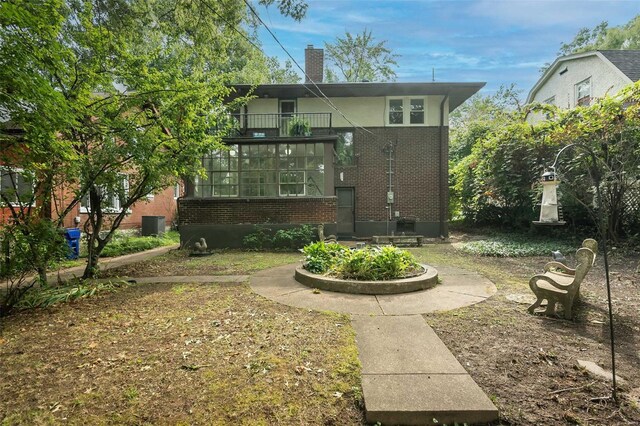 back of property featuring a balcony