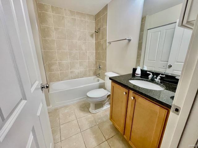 full bathroom with toilet, tile patterned flooring, vanity, and tiled shower / bath