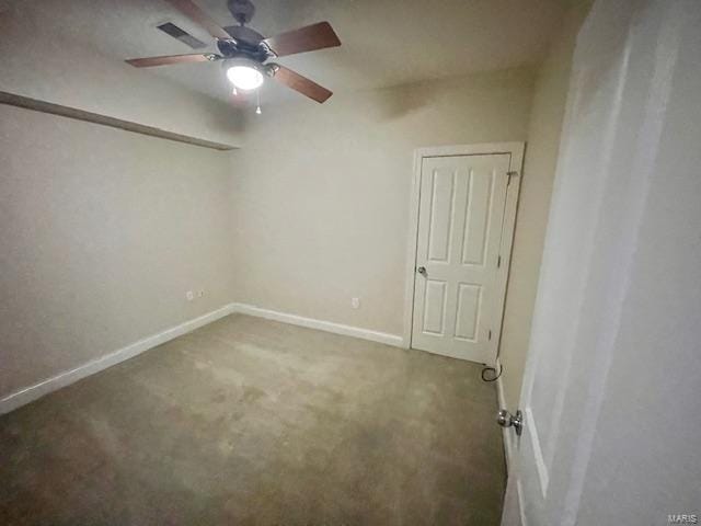 carpeted spare room featuring ceiling fan