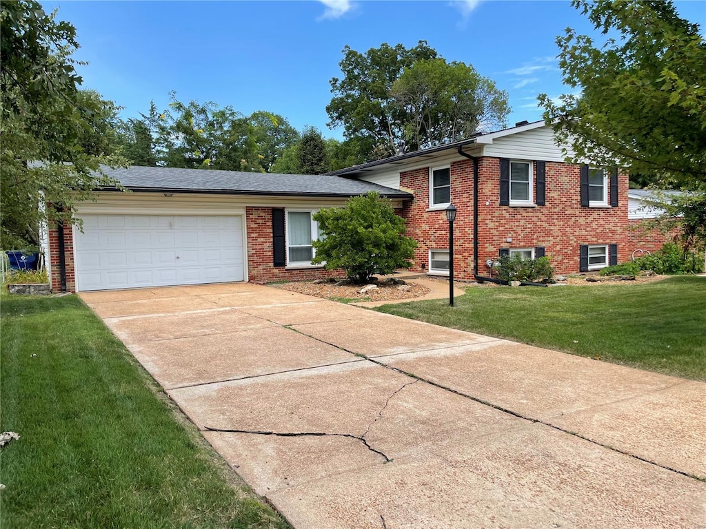 split level home with a front lawn and a garage