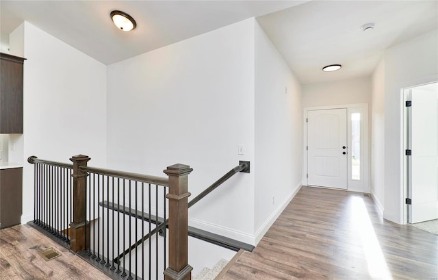 hall with wood-type flooring