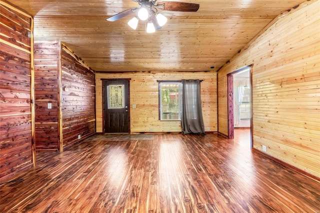 spare room featuring wood ceiling, vaulted ceiling, wood walls, and wood-type flooring