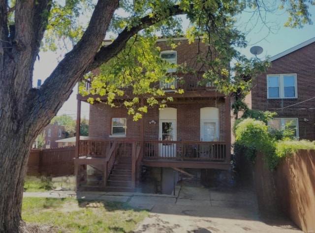 back of property featuring brick siding and fence