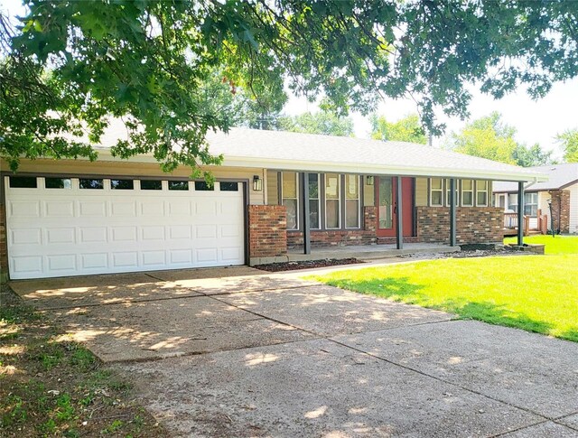 single story home featuring a garage and a front yard