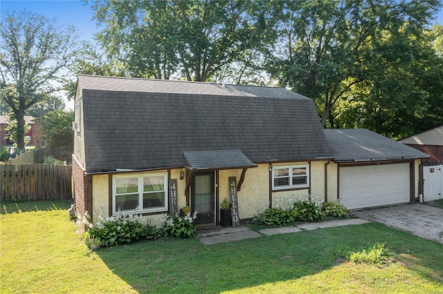 view of front of home with a garage and a front lawn