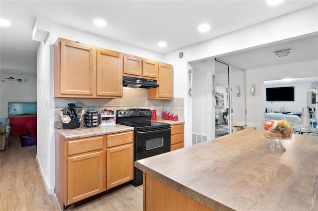 kitchen with light wood-type flooring, light brown cabinets, black range with electric cooktop, and backsplash