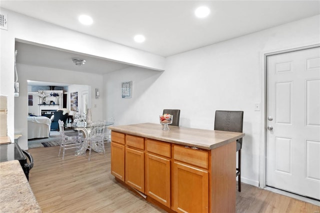 kitchen with light wood-type flooring and a center island