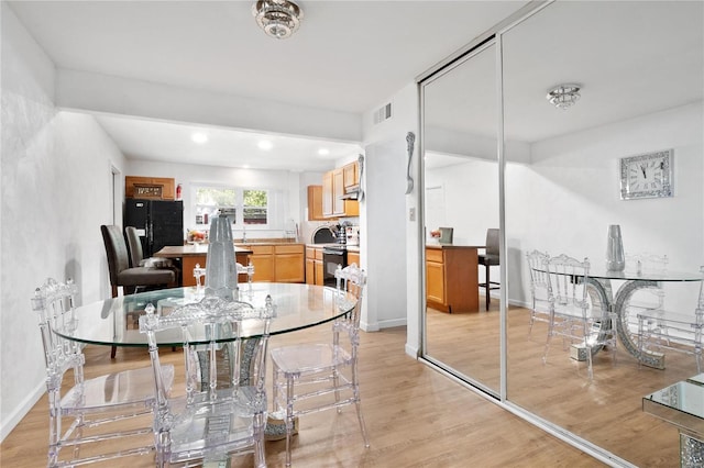 dining space with light wood-type flooring