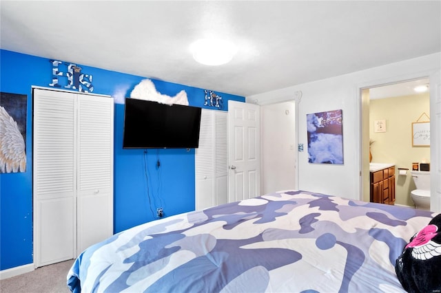 bedroom featuring carpet and connected bathroom