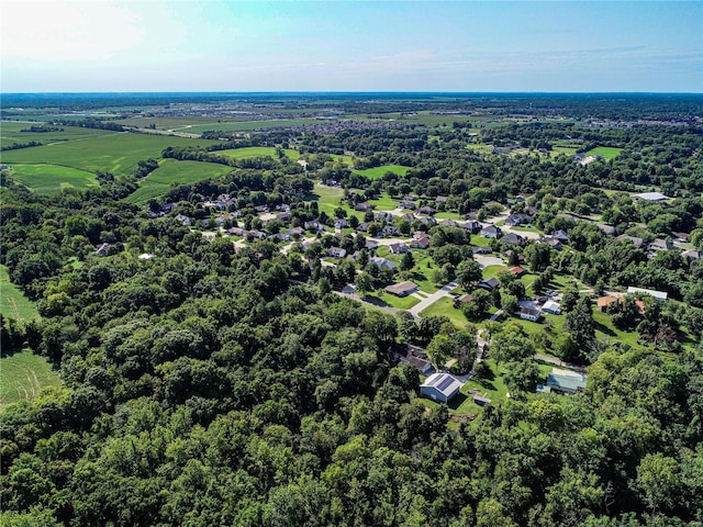 birds eye view of property featuring a view of trees