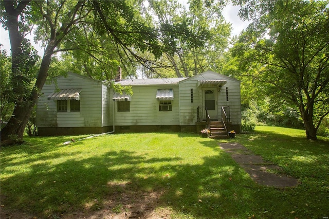 manufactured / mobile home with a chimney and a front lawn