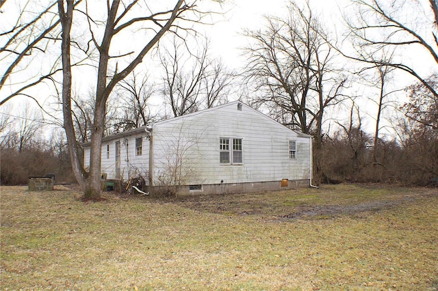 view of side of home with a lawn