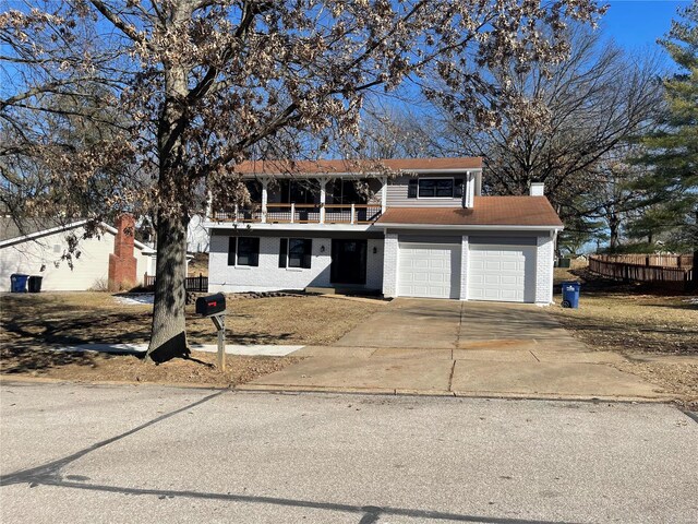 front of property featuring a garage and a balcony