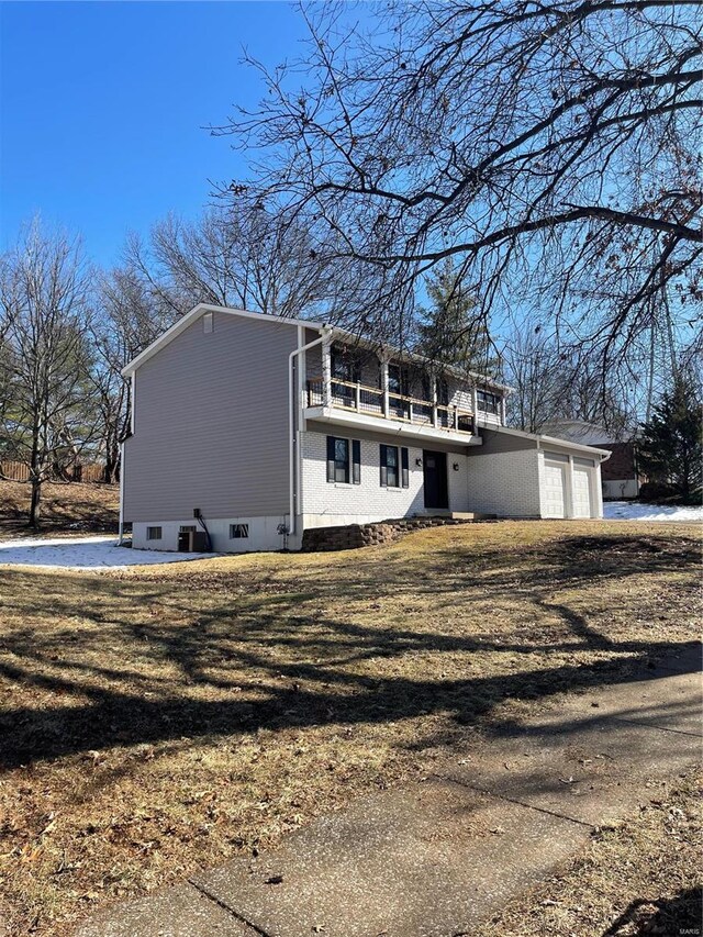 view of home's exterior featuring a yard and a balcony