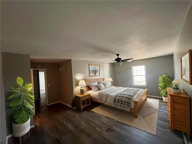 bedroom with dark hardwood / wood-style flooring and ceiling fan