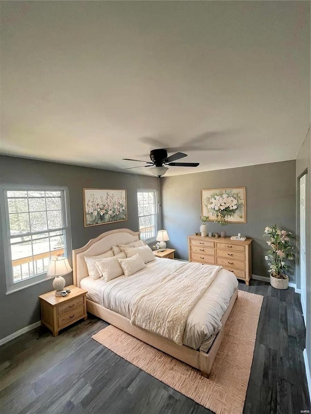 bedroom with ceiling fan and dark hardwood / wood-style floors