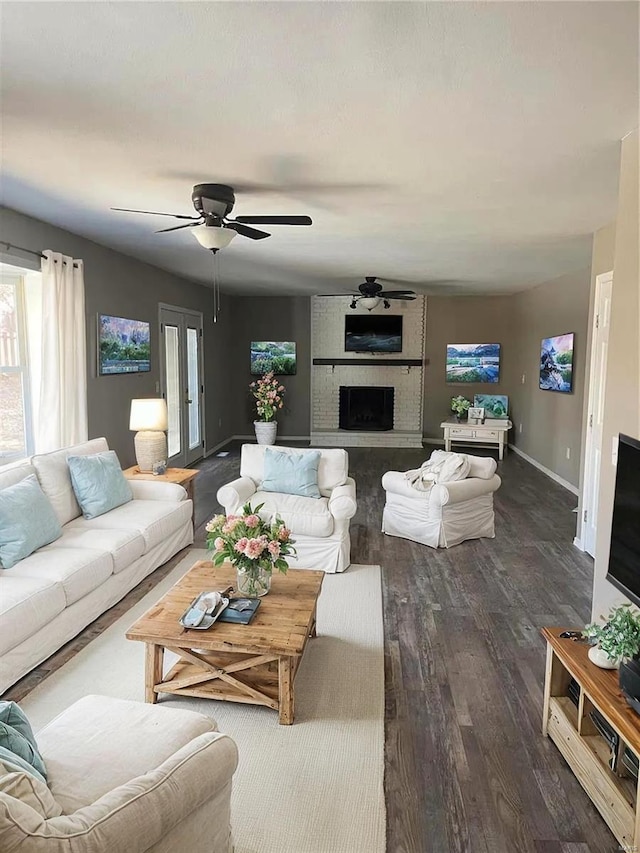 living room featuring a fireplace, dark hardwood / wood-style flooring, and ceiling fan